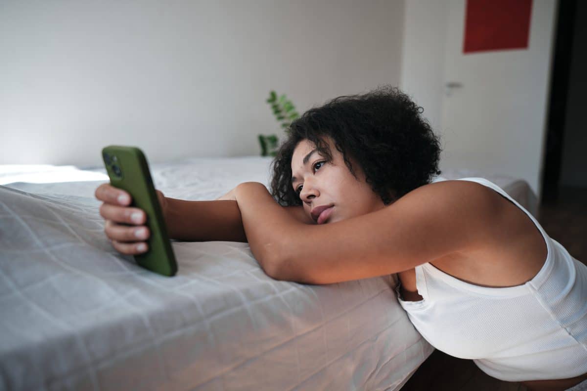 Digital Devices And Mental Health. Upset African American Woman Looking At Smartphone Screen Feeling Sad Reading Sms Message Scrolling On Social Media
