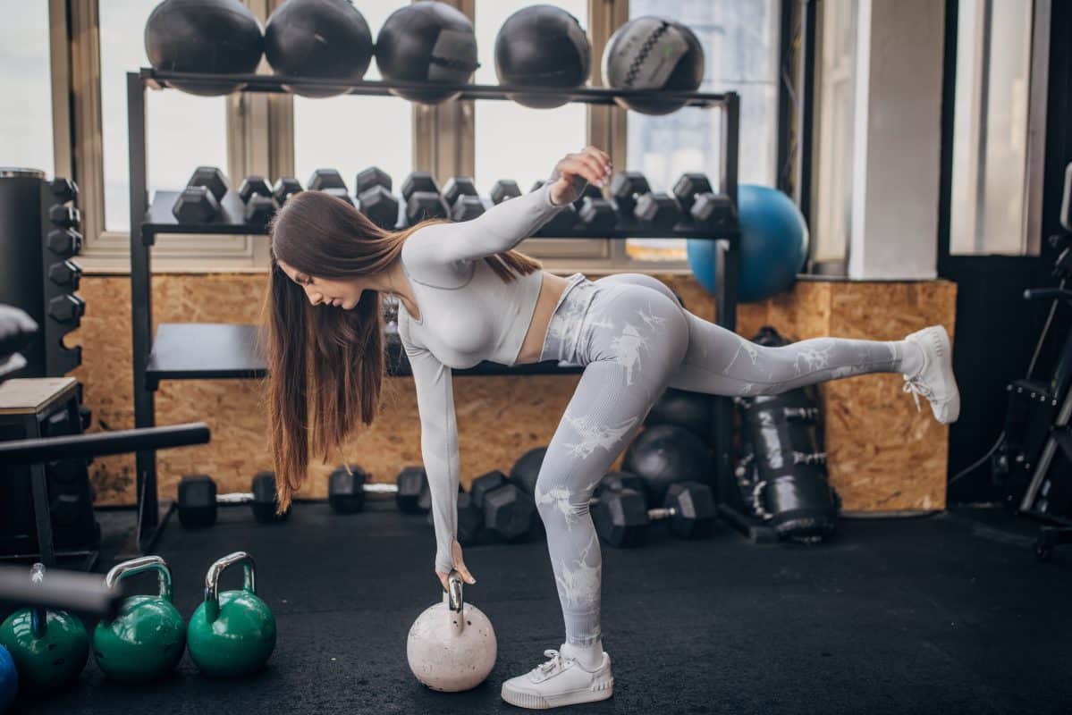 Woman Performing Single Leg Deadlift With Kettlebell