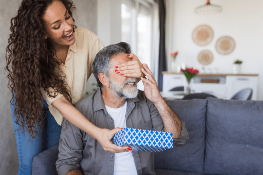 Vrouw geeft vaderdagcadeau aan vader