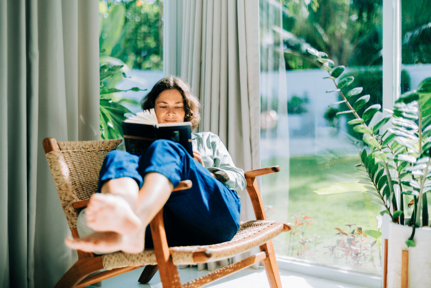 Vrouw leest boek in een stoel