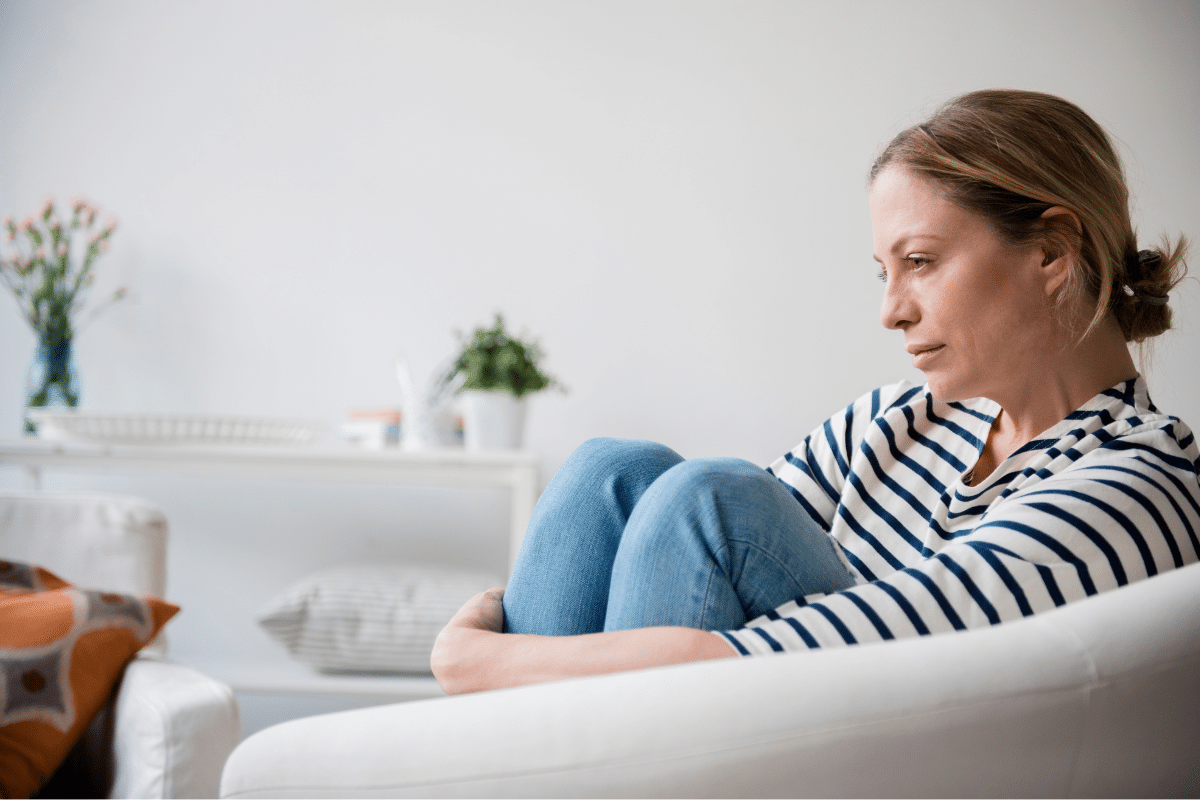 vrouw zit op de bank met geldstress